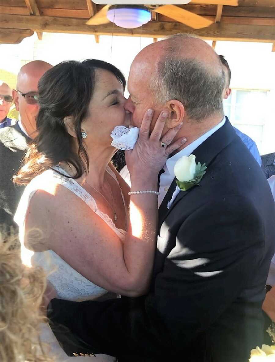 newly married couple kiss for the first time after the wedding ceremony