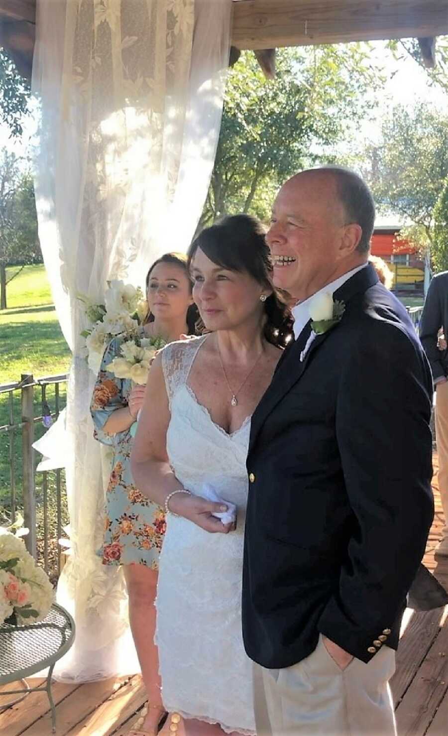 couple celebrates wedding ceremony at at deck after being together for 20 years and husband's cancer diagnosis 