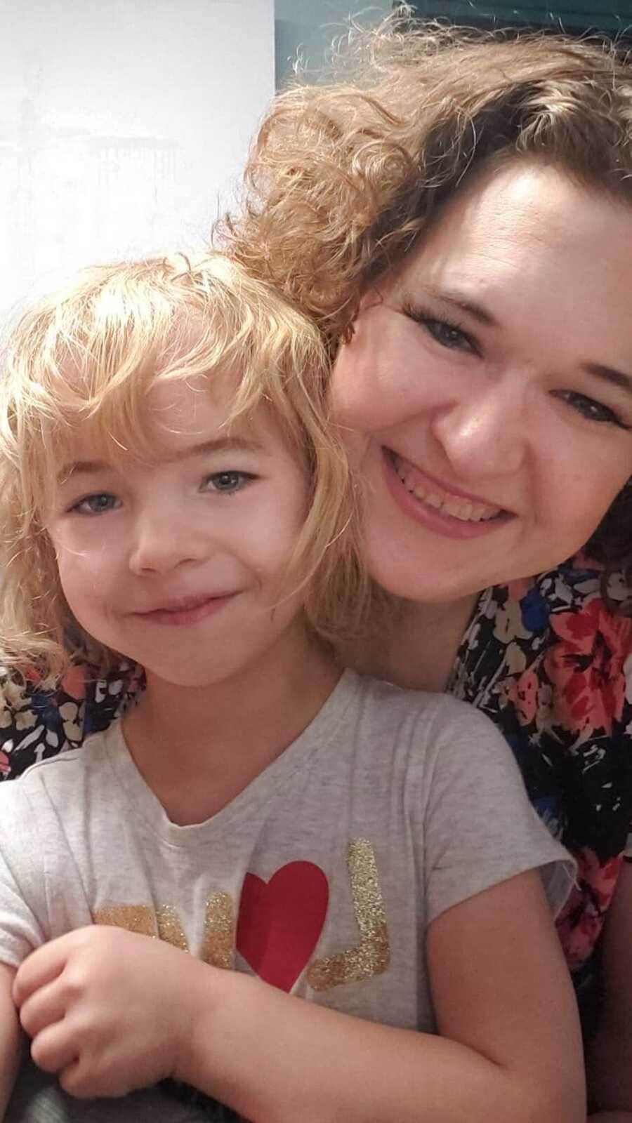 mom and daughter smiling