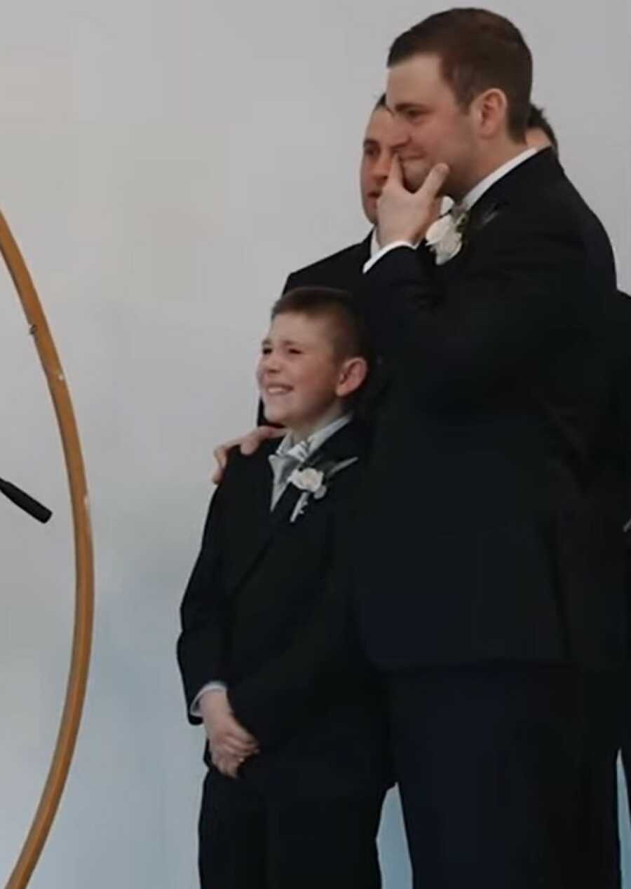 husband and stepson crying at their wedding