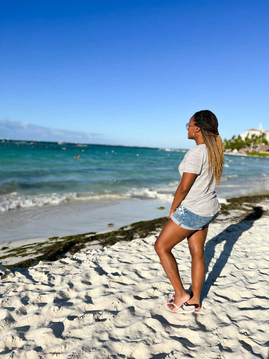 woman looking out at the beach and enjoying a new start