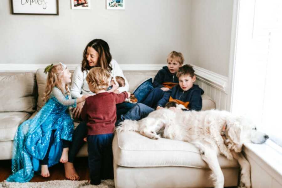 mom playing with her kids and the dog