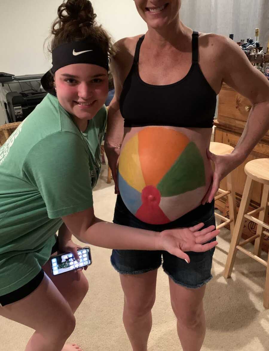 mom with belly painted like a beach ball