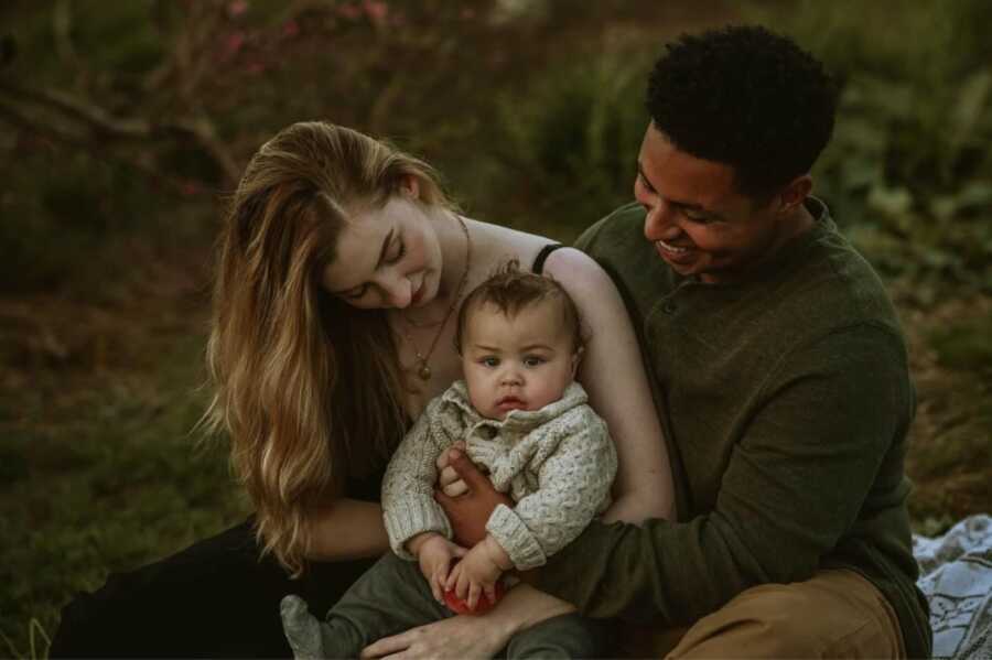 mom dad and son smiling for a photo