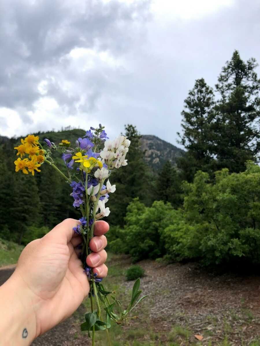 woman holding wild flowers