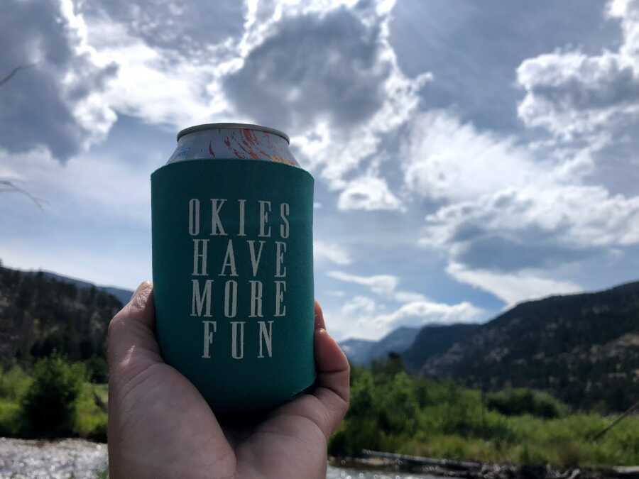 woman having a drink while on a hike