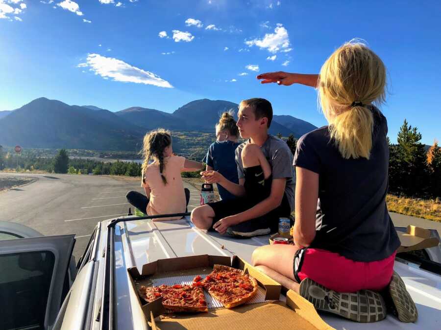 sitting on the top of the car