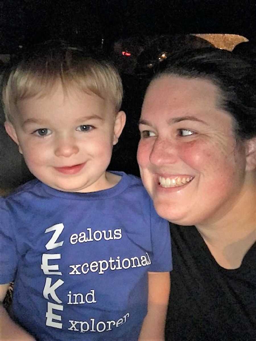 mom looking at autistic son, who is wearing a shit with his name 'ZEKE' 