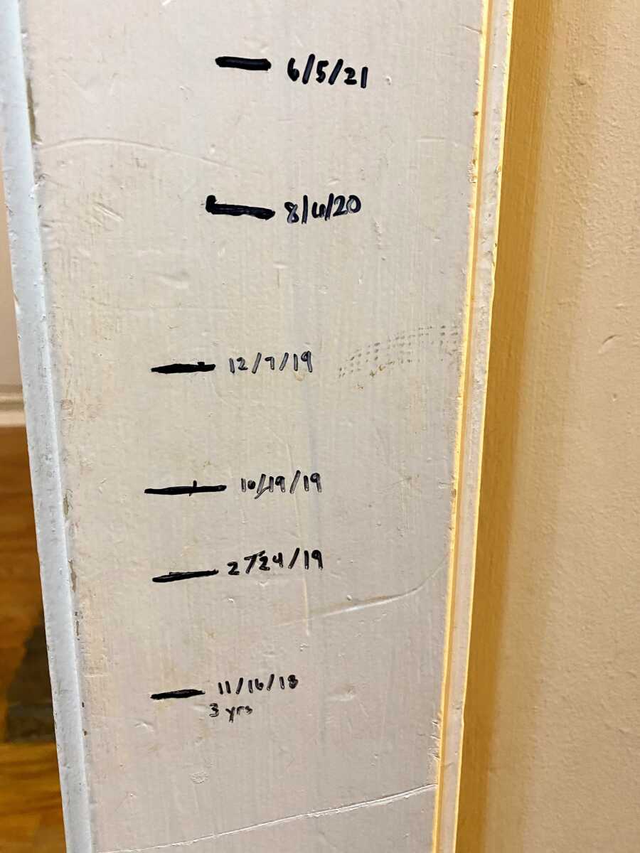 homemade Wall Height Chart made with sharpie on white wall 