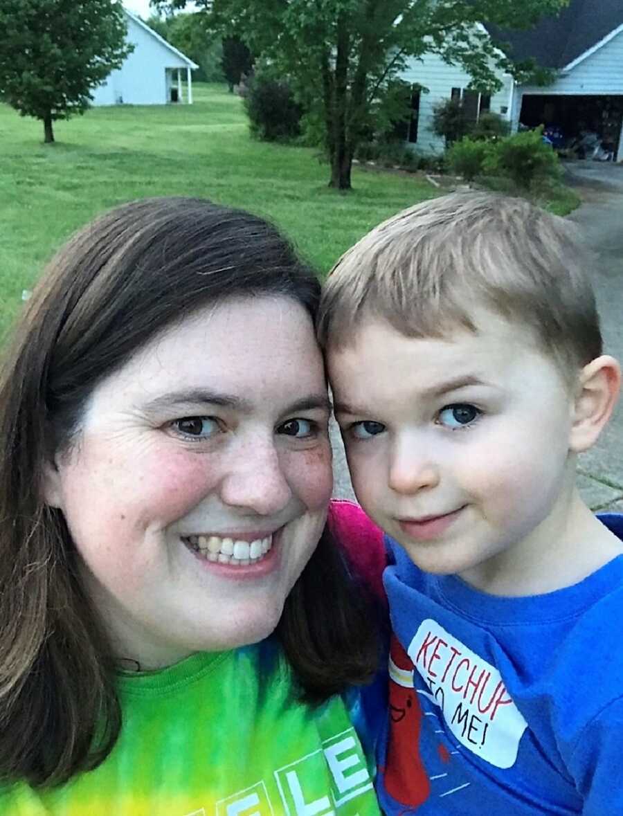 special needs mom and autistic son's selfie in front of their home 