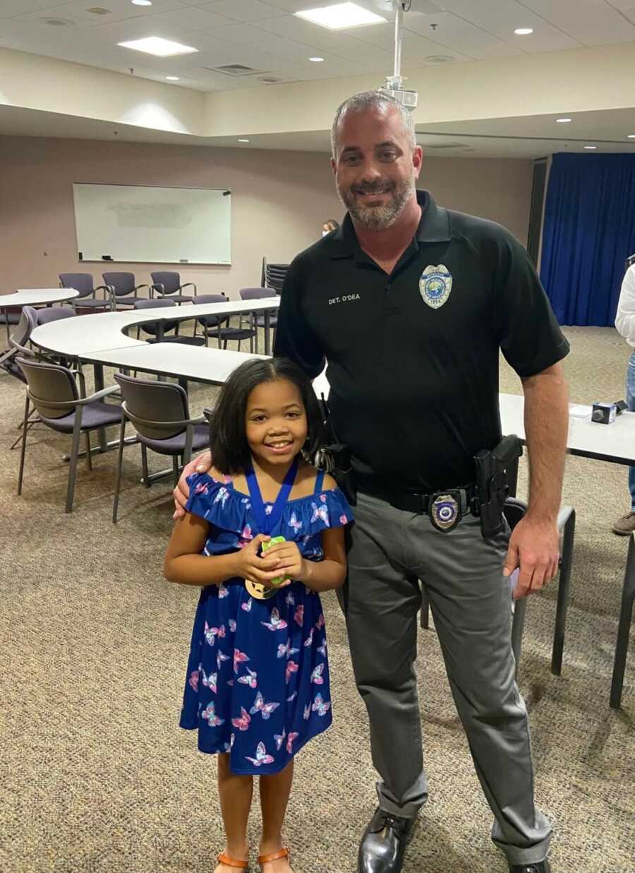 little girl smiling with her medal