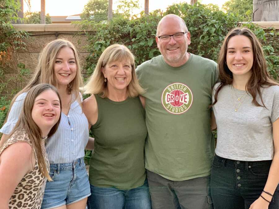 girl with down syndrome with her family