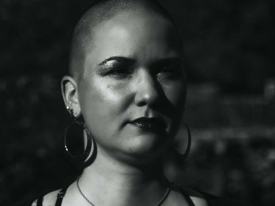 woman posing with her head shaved