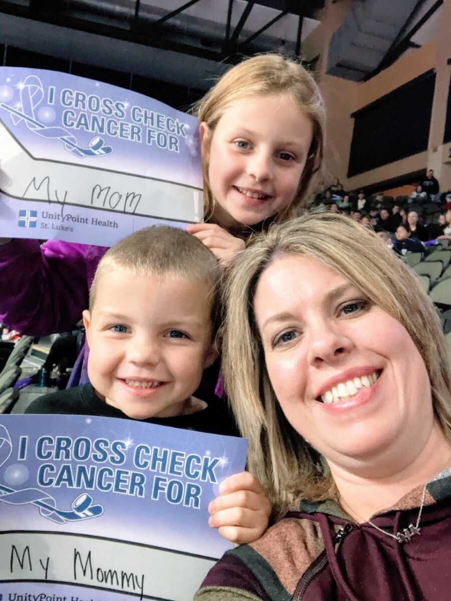 Mom takes a selfie with her two kids at a cancer fundraising event