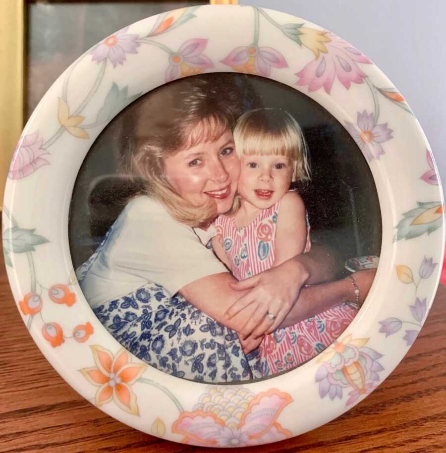 mom holding her daughter close