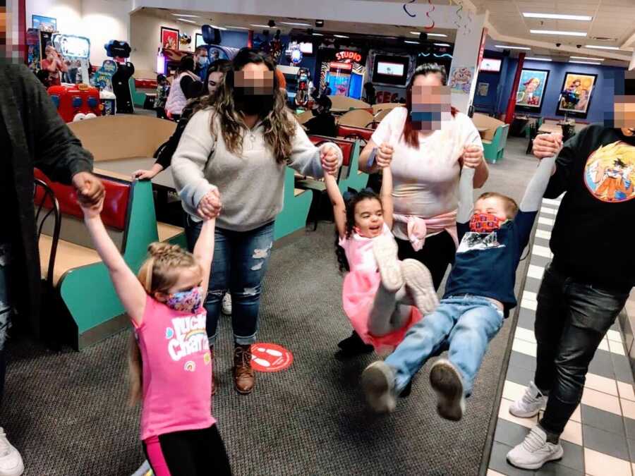 Blended family take group photo at a Chuck-E-Cheese