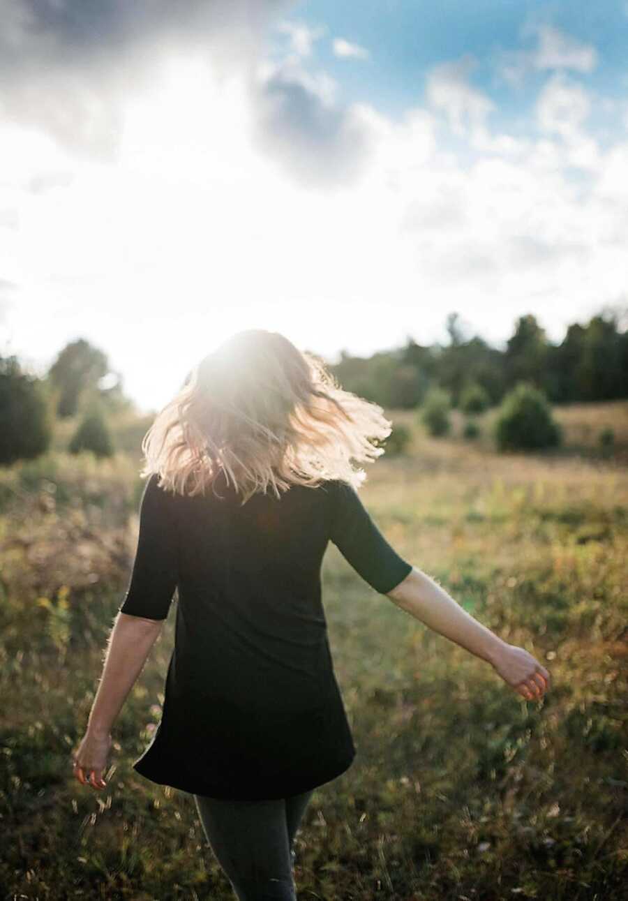 Woman on healing journey from childhood sexual abuse dances in the sunshine