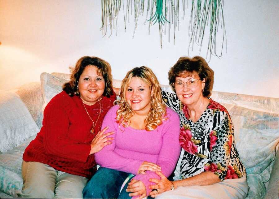 Young adoptee smiles with her adopted mom and birth mom