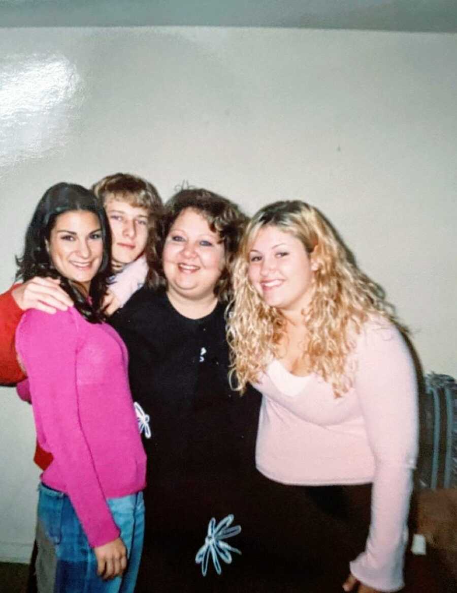 Young adoptee takes a photo with her biological family