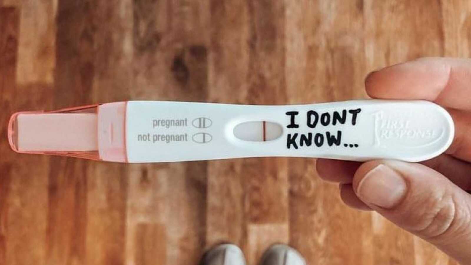 Woman writes 'I don't know' on a negative pregnancy test