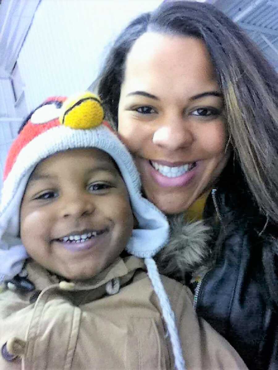 Teen mom takes selfie with toddler son wearing an Angry Birds beanie