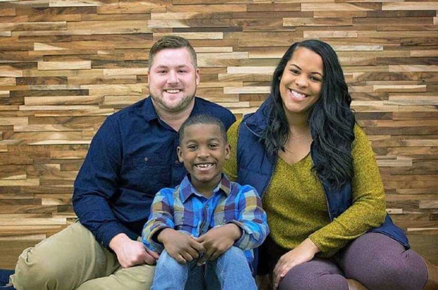 Interracial family take a photo fall-themed family photo together