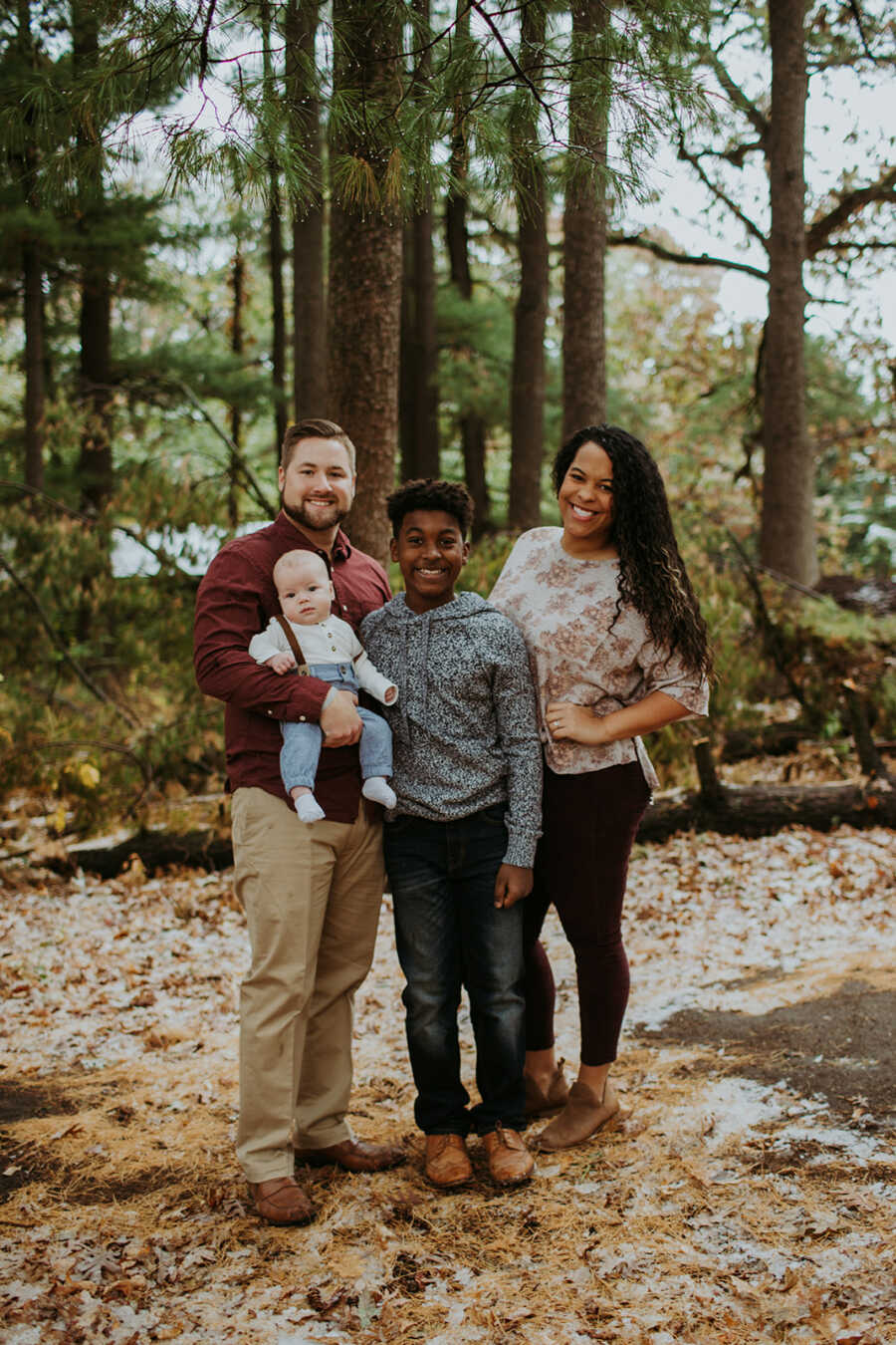 Blended family of four take photos together during the fall time