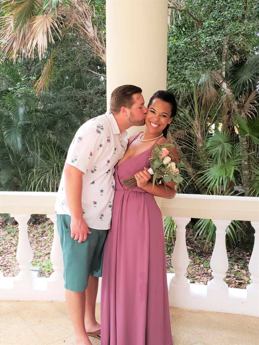 Young interracial couple share intimate moment during wedding photos 