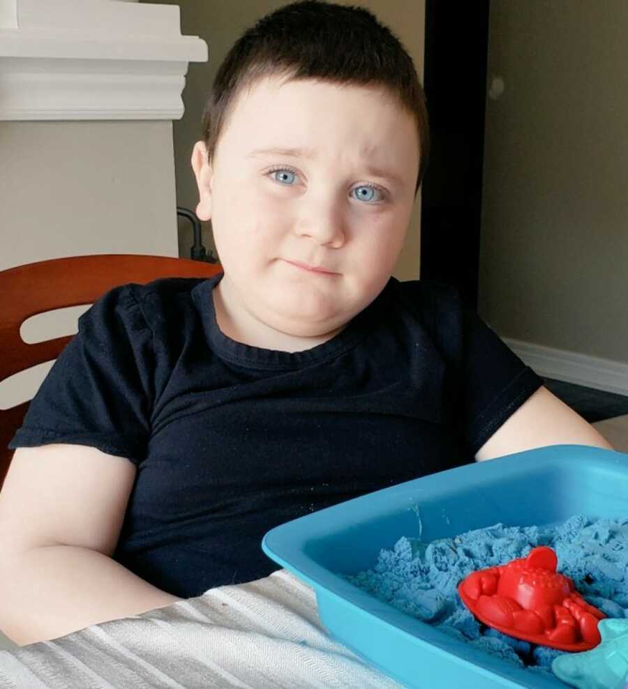 little boy sitting at the table eating