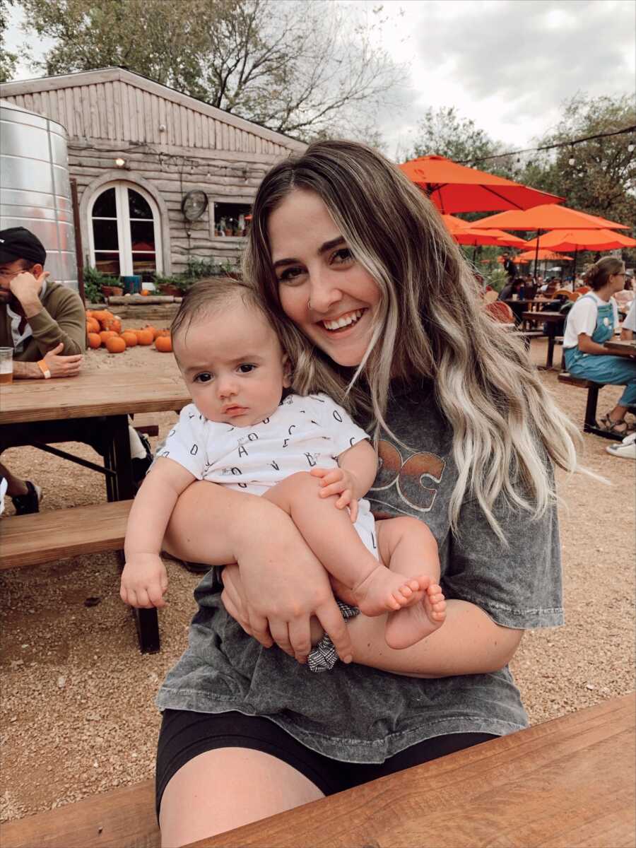 mom holding her son close smiling