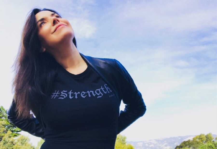 Empowerment coach for adult adoptees wearing a shirt with the word strength 