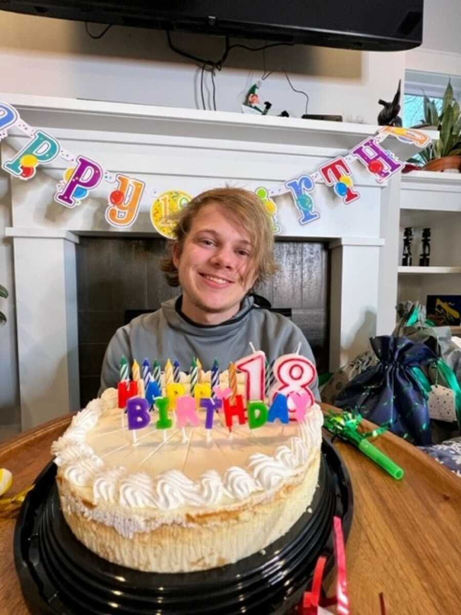son on his 18th birthday with his cake and presents