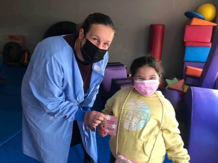 little girl spreading kindness with cards