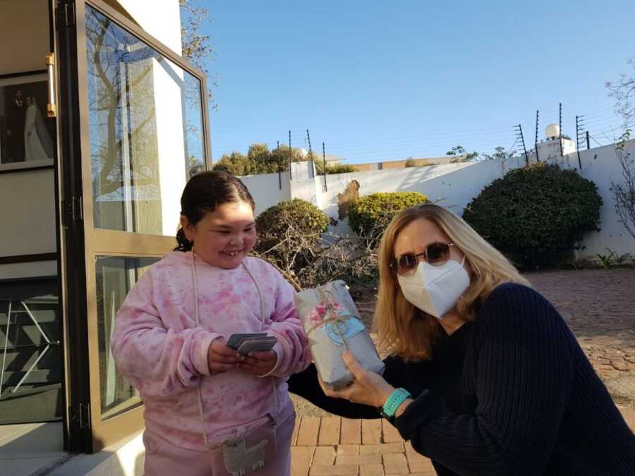 little girl spreading kindness with cards