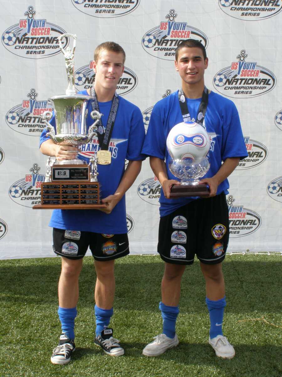 teen boy with his trophy from soccer