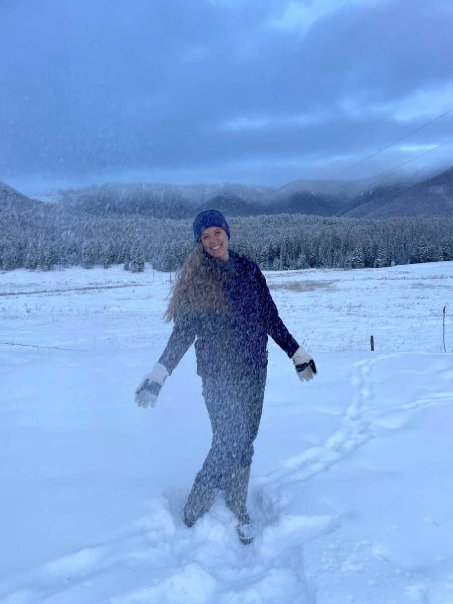 woman standing in the snow 