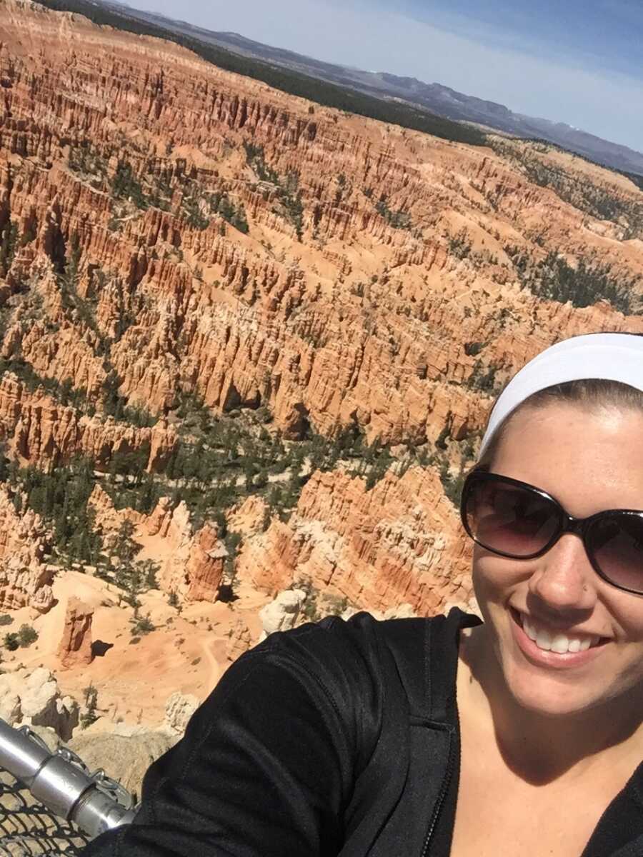 woman taking a selfie in front of a canyon 