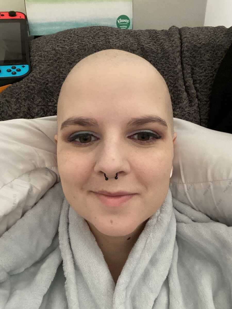 woman with breast cancer takes selfie in a robe