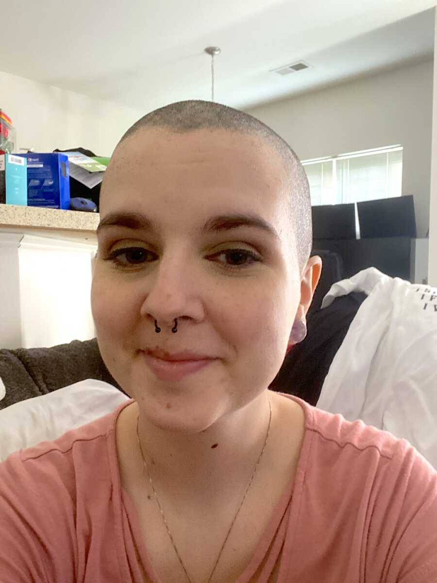 breast cancer fighter takes smiling selfie in pink shirt