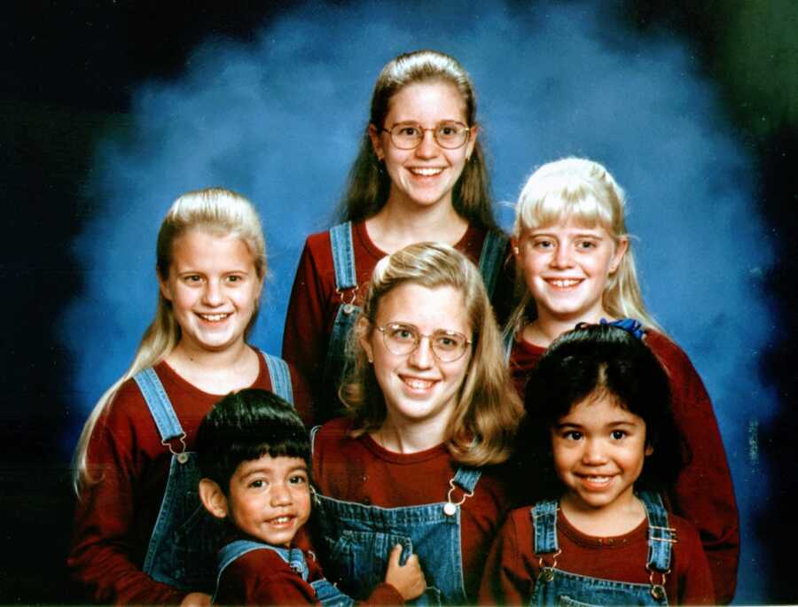 Four sisters take photos with adopted brother and sister, all in matching outfits