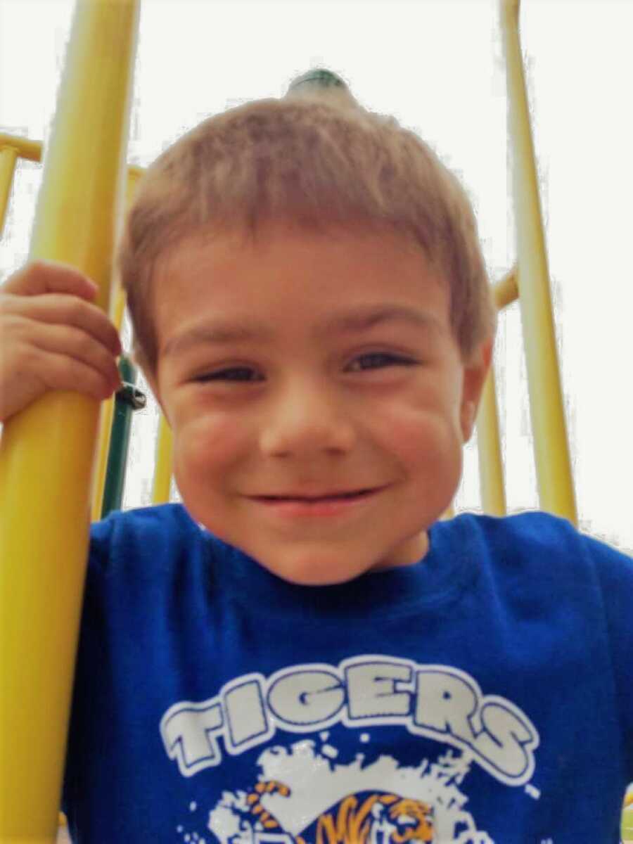 adopted son on a play ground smiling 