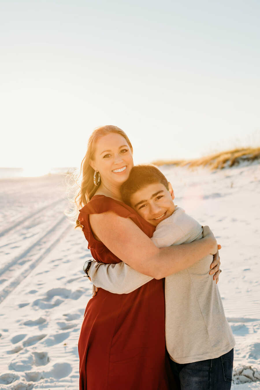 adopted son hugging mom close