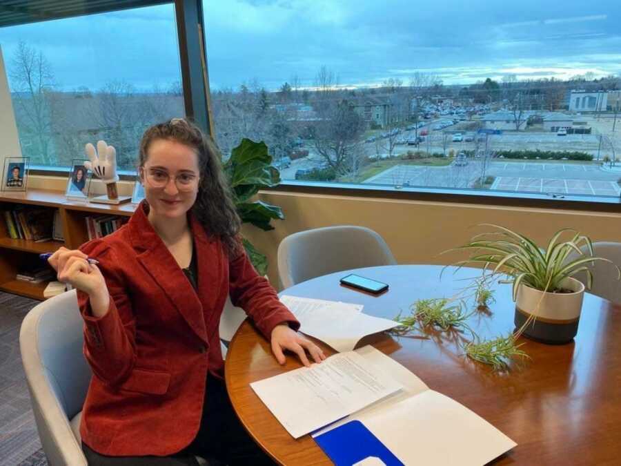 woman signing the documents for the scholarship