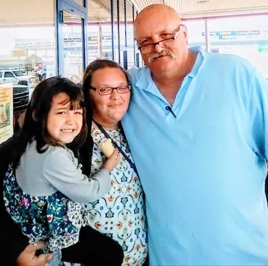 daughter poses with her father who was formerly incarcerated, along with her daughter, his granddaughter 