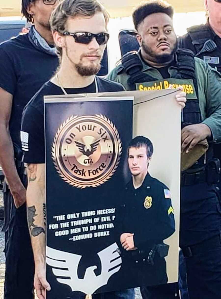 man holds photo of his brother who had passed away from a gunshot wound