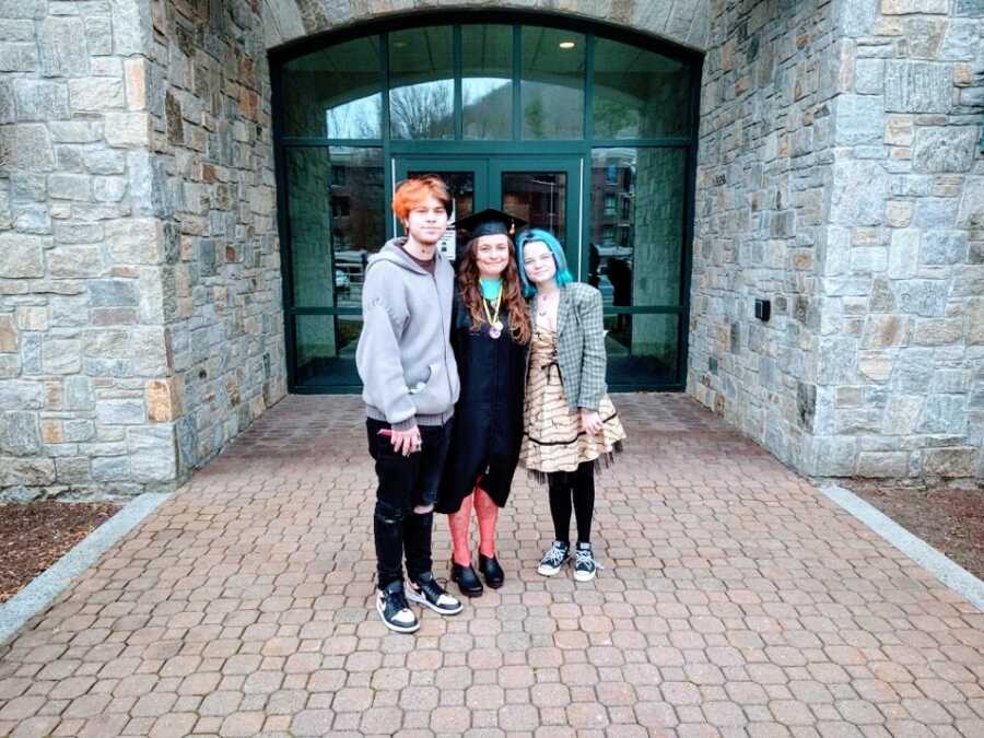 A mom at her college graduation with her two children