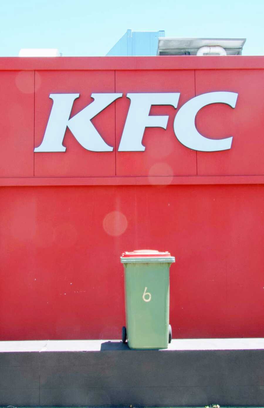 garbage can is brought to and placed in front of a KFC restaurant
