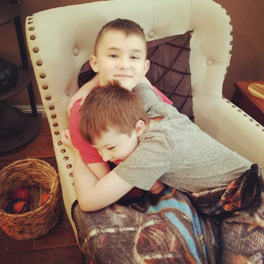 Brothers with Duchenne Muscular Dystrophy hug each other. 