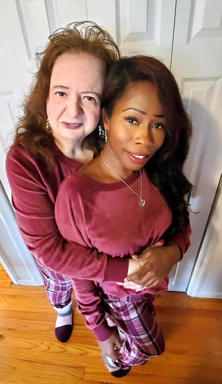 Woman and adopted adult daughter embrace. 