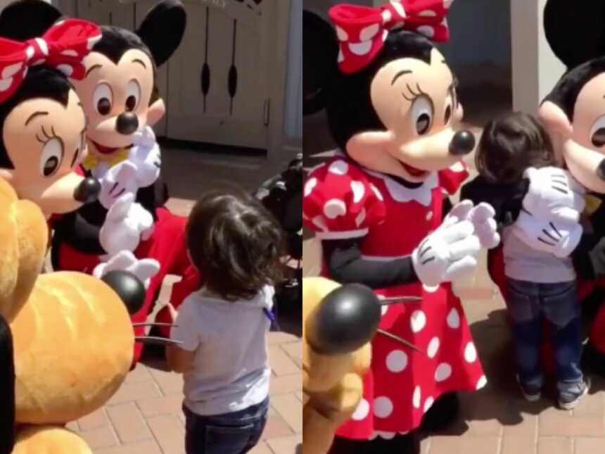 Deaf boy hugs signing Mickey Mouse